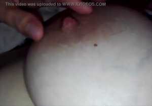 A cute lady with nice tits is having fun with her nipples